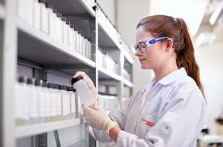 Laboratory assistant with sample of peracetic acid sample of peracetic acid