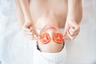 woman in spa portrait of young beautiful woman in spa while holding tomato on face