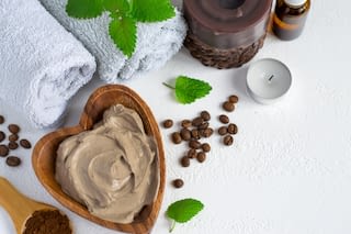 Spa setting Spa setting with cosmetic clay mask for body, Towel Essential oil and coffee beans