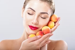 Beautiful woman holding a juicy apricot Beautiful woman holding a juicy apricot